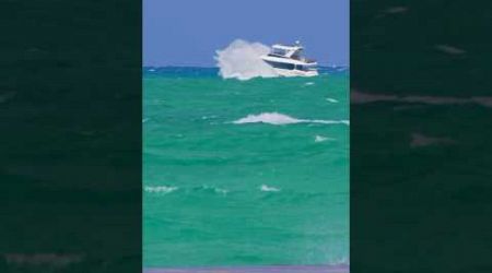 Yacht stuffing spotted in the distance on Crazy Sunday at the Haulover Inlet in Bal Harbour, Florida