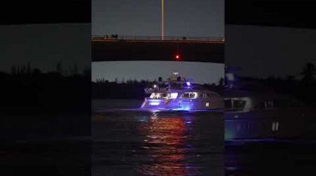 Spectacular night capture of huge yacht under the Haulover Inlet bridge.