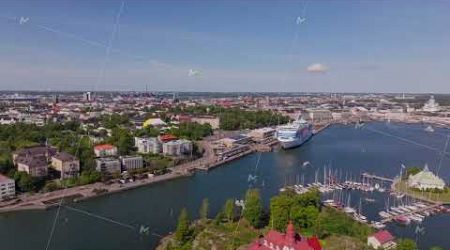 Helsinki, Finland, showcases its harbor teeming with a ferry ship and yachts, overlooked by a