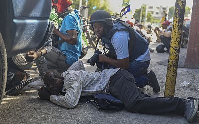 Haiti swears in a new leader as gangs shoot at a flight landing in the main airport