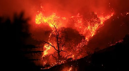 Thousands under evacuation near Los Angeles as wildfire torches homes