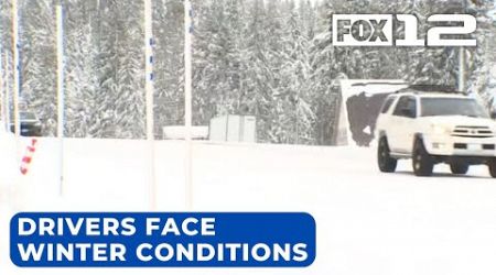 Drivers chain up to travel Cascades passes amid snowstorm warning