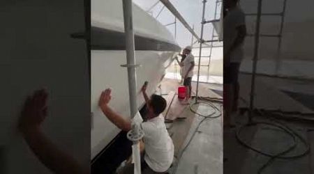 Shows how yachts are tented, for painting, while vessel is still in the water.