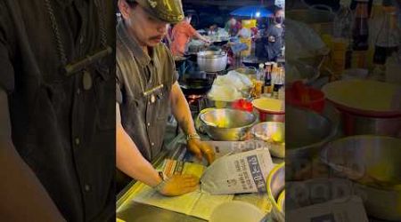 Newspaper! Stir fried chicken with basil wrapped in newspaper in Surin Thailand