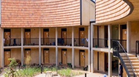 MASS Design Group uses earthen walls for Rwandan university campus