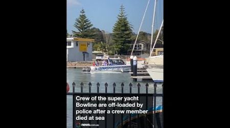 The crew of the retired super yacht Bowline are off-loaded by police