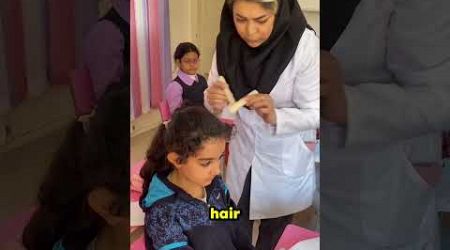 Teacher Checking for Head Lice at School 