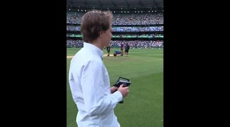 Oscar Piastri drives the roving camera around the MCG