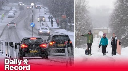 Amber weather warning remains after heavy snow causes travel disruption across parts of UK