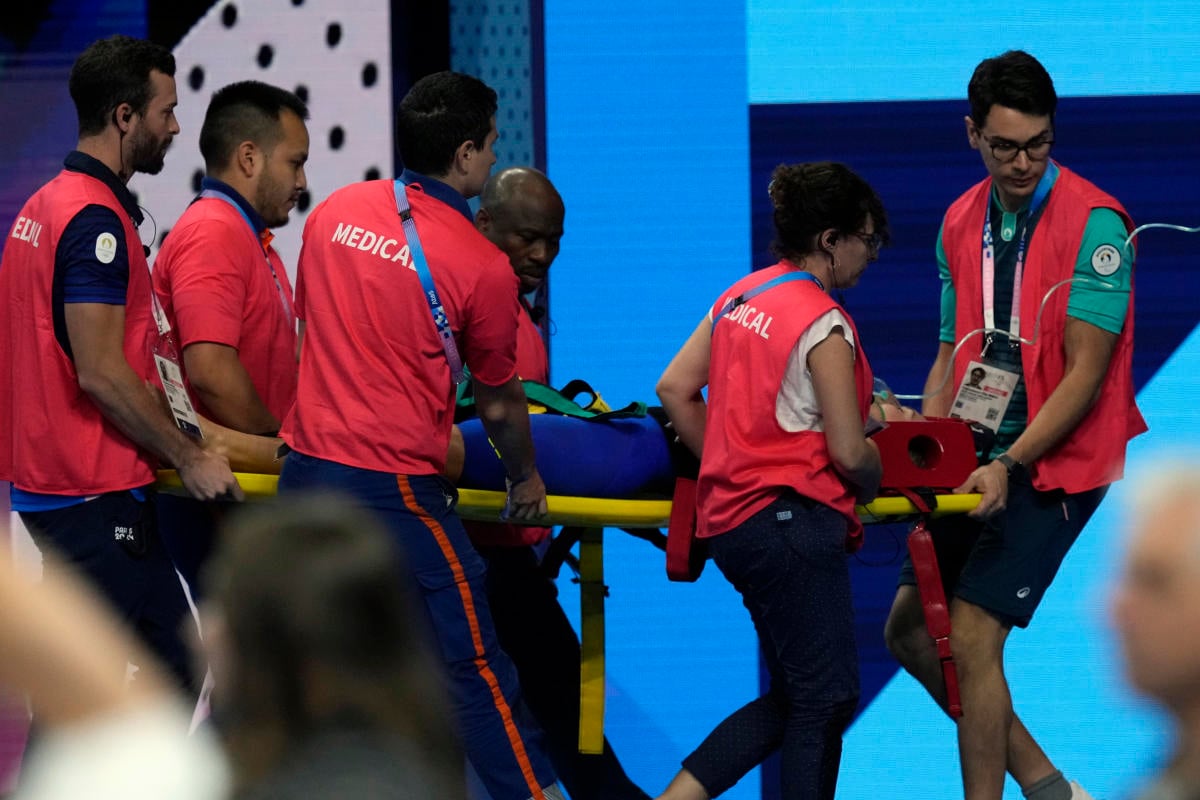 Swimmer Tamara Potocka collapses after a women’s 200-meter individual medley race at the Olympics